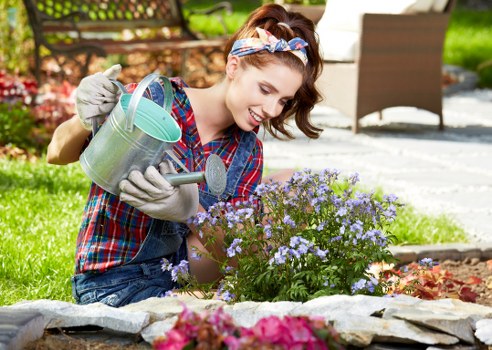 Professional gardener applying safe working practices on a garden site